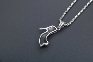 Detailed view of a silver stiletto high heel pendant necklace with black enamel inlay
