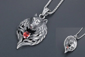 Macro shot of silver fox pendant with red zircon inlay and detailed carved textures