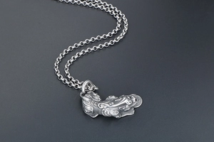 Macro shot of vintage titanium steel PiXiu pendant necklace with antique silver finish