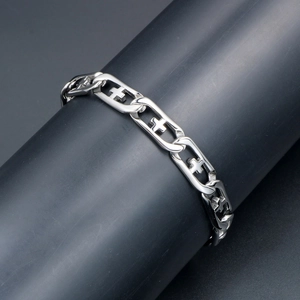Polished titanium steel chain bracelet with hollow cross links on a jewelry display