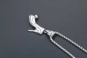 Detailed macro view of a polished silver high heel stiletto pendant necklace