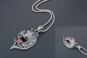 Close-up of titanium steel wolf head pendant with red zircon and silver vintage chain