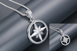 Detailed macro view of a vintage silver star compass pendant on a square box chain