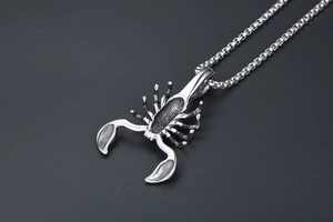 Macro shot of titanium steel scorpion pendant with detailed vintage silver finish textures