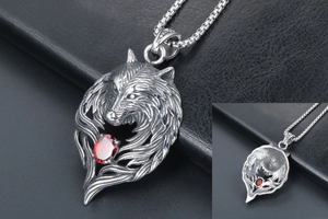 Detailed macro view of vintage silver wolf head pendant with a red zircon stone