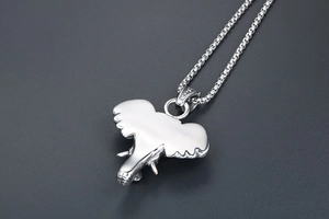 Macro detail of silver elephant head pendant in polished stainless steel on box chain