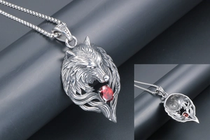 Macro detail of silver wolf head pendant with red gemstone and hollow back structure