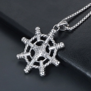 Silver steering wheel rudder pendant necklace with box chain for men on leather surface