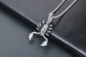Macro shot of detailed stainless steel scorpion pendant with intricate tail textures