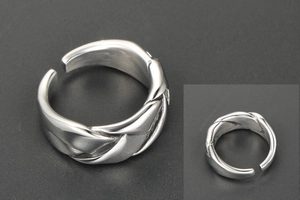 Macro detail of silver woven texture and adjustable open band on hip-hop steel ring