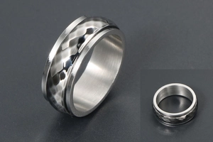 Close-up of vintage spinner ring with hammered black metal band and silver edges