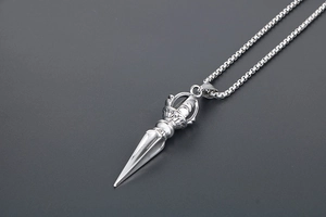 Detail view of titanium steel Vajra pestle pendant with retro engraved textures