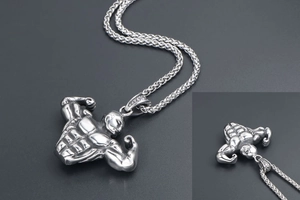 Detail view of silver stainless steel bodybuilding pendant with muscular athlete profile