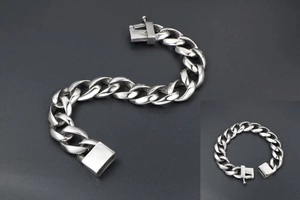 Detailed macro view of high-polish titanium steel Cuban link bracelet with a secure box clasp