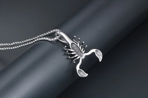 Detail of vintage silver titanium steel scorpion pendant on a premium box chain