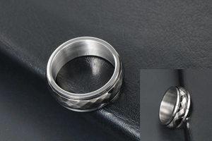 Detail view of silver punk ring featuring geometric faceted texture on black leather background