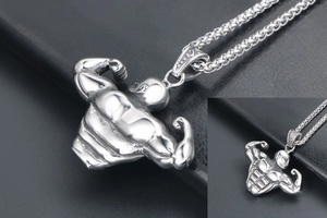 Macro shot of silver titanium steel bodybuilding necklace with detailed muscle pendant