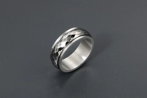 Macro shot of men's two-tone ring featuring a dark hammered texture and silver brushed edges