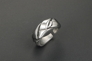 Detailed view of silver braided stainless steel ring with polished adjustable open band
