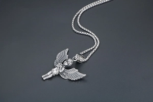 Macro view of detailed silver angel cupid pendant on a classic round box chain necklace