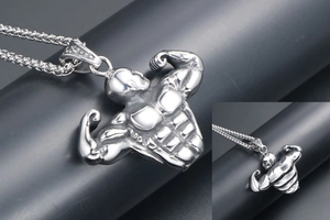 Close-up of silver-tone stainless steel bodybuilder pendant with detailed muscle carving