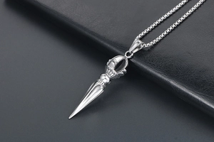 Macro shot of silver titanium steel Phurba pendant on a box chain with detailed carving