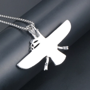 Polished silver eagle pendant necklace with box chain on dark minimalist background