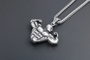 Detailed view of silver titanium steel bodybuilding pendant with muscular male figure