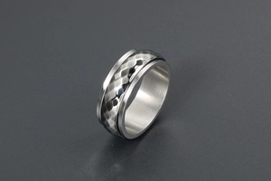 Detail of the hammered texture on a silver spinning ring with industrial punk design