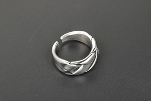 Close-up of industrial silver woven texture on adjustable stainless steel band