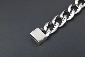 Macro shot of silver Cuban link bracelet with durable square clasp and polished finish