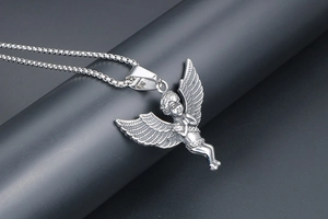 Close-up of titanium steel guardian angel pendant with detailed wings on a silver chain