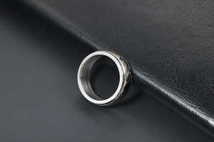 Close-up of vintage punk spinning ring with hammered geometric facets and silver finish