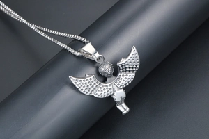Detail view of silver cherub angel pendant with intricate wings on a titanium steel chain