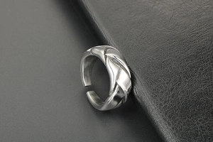 Detailed close-up of the woven texture and silver metallic finish on this adjustable ring