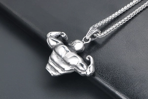Macro view of men's titanium steel bodybuilder pendant with detailed muscle texture