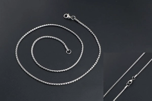 Close-up of silver titanium steel rope chain with detailed braid texture and lobster clasp