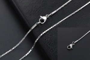 Close-up of a silver stainless steel cable chain with a durable lobster clasp detail