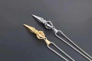 Detailed comparison of gold and silver Vajra Phurba Buddhist pendants on chains