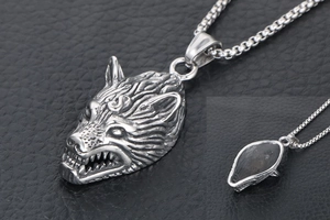 Close-up of vintage titanium steel wolf head pendant with detailed fur texture and engraving