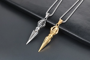 Detailed macro view of gold and silver Vajra pendants on high-quality square link chains