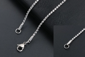 Detailed macro view of silver twisted braid chain with secure lobster clasp closure