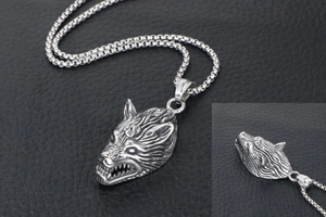 Macro detail of silver titanium steel wolf head pendant with textured fur and box chain