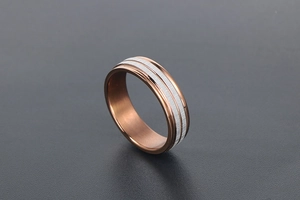 Macro shot of two-tone coffee-colored titanium ring with silver brushed metal stripes