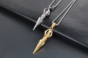 Detailed macro view of two-tone titanium steel vajra pendants with polished finish