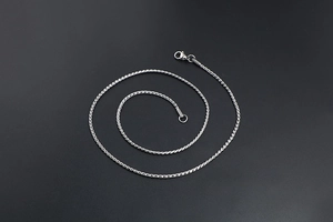 Detailed macro view of silver twisted rope chain with a sturdy lobster clasp closure