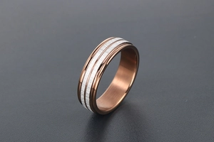 Macro detail of brown and silver titanium steel ring with double brushed metal stripes