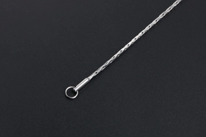 Macro shot of polished silver stainless steel link chain with cylindrical closure