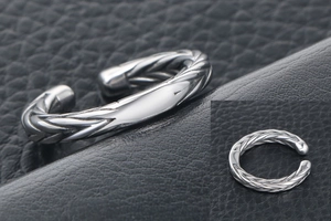 Macro view of vintage titanium steel ring with twisted rope texture and silver finish