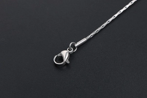 Close-up of minimalist silver stainless steel chain with a secure lobster clasp closure